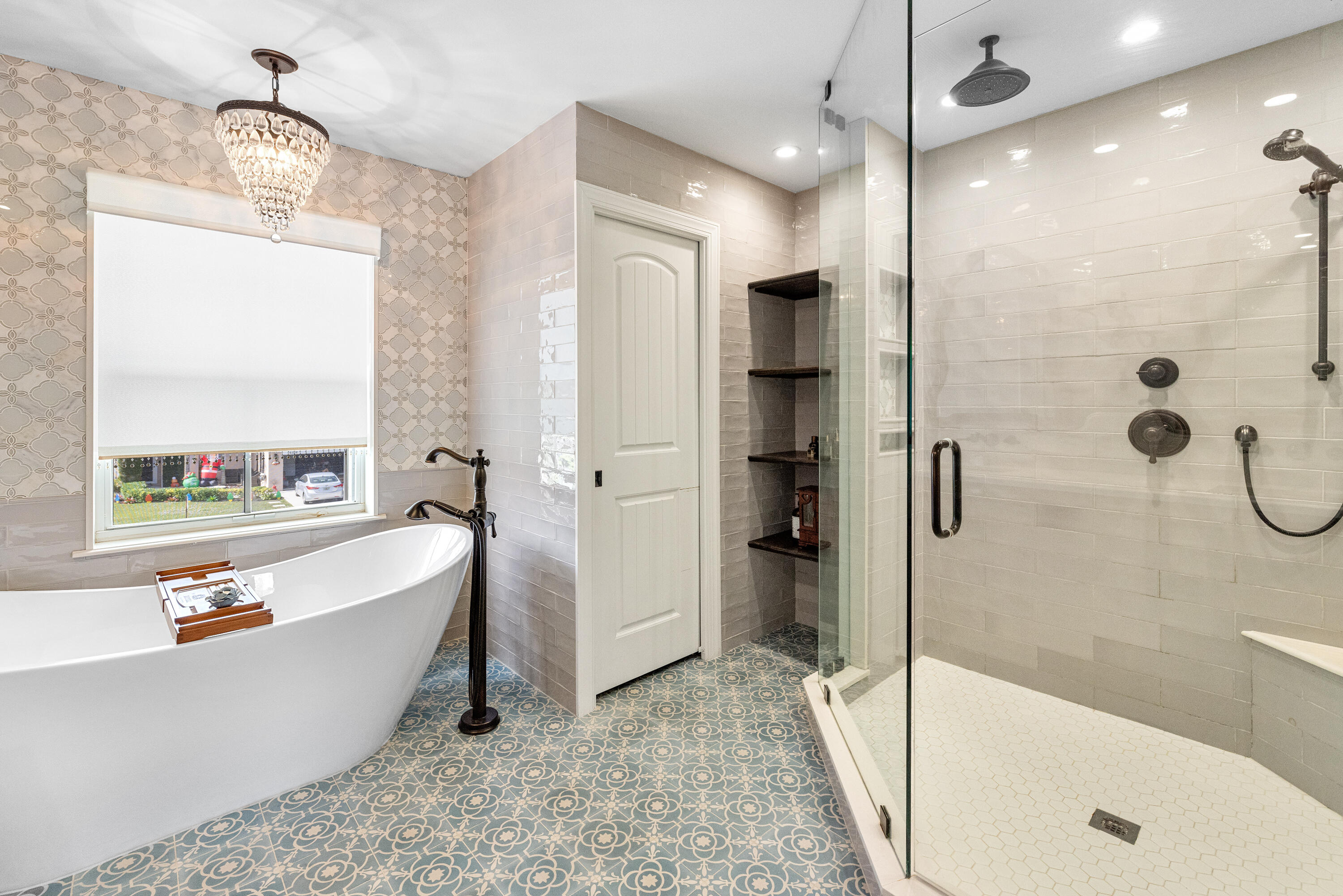 6575 Spring Meadow Drive Greenacres, FL 33413 - Photo 24 of 51 a bathroom with a tub a sink a mirror and a shower