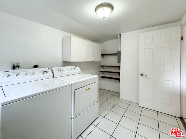 a utility room with a sink dryer and washer