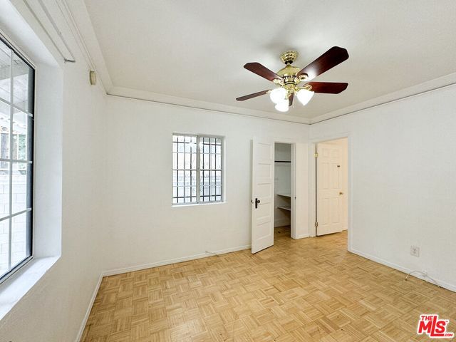 a room with black white checkered floor furniture and a large window