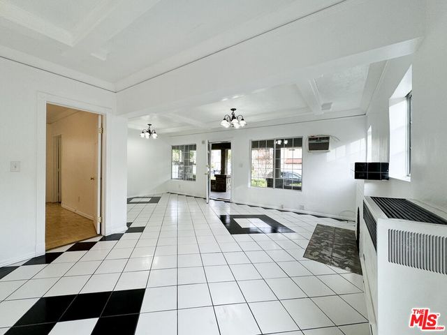 a bedroom with a bed and a potted plant