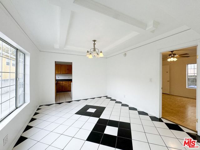 a kitchen with granite countertop a stove a sink and a refrigerator