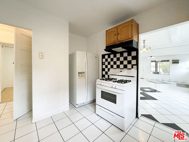 a kitchen with stainless steel appliances a stove a sink and a microwave