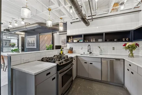 a kitchen with a sink and a stove top oven