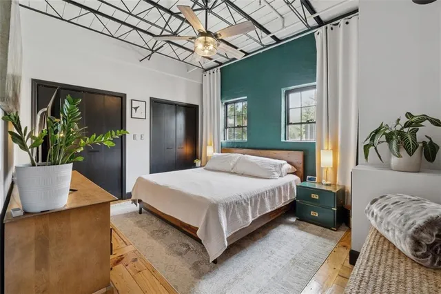 a bedroom with a bed and with potted plant