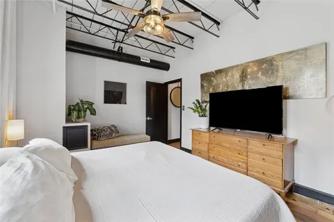 a bedroom with a bed and a flat screen tv