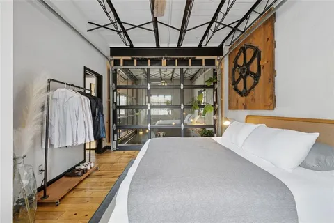 a bedroom with a bed and a mirror