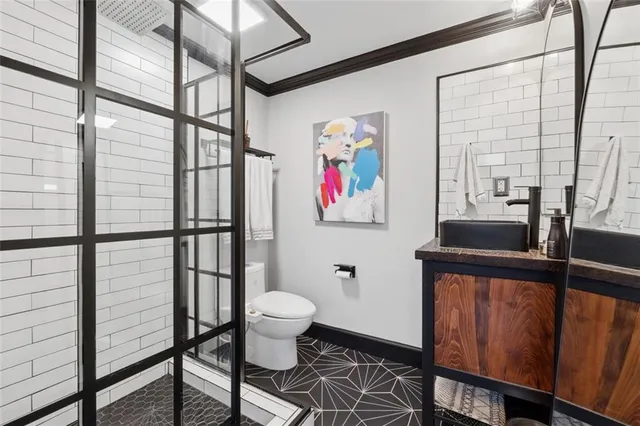 a bathroom with a sink toilet and a shower