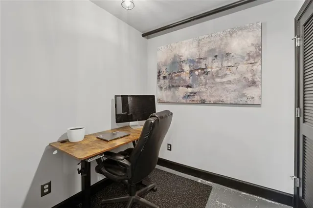 a view of workspace with wooden floor windows