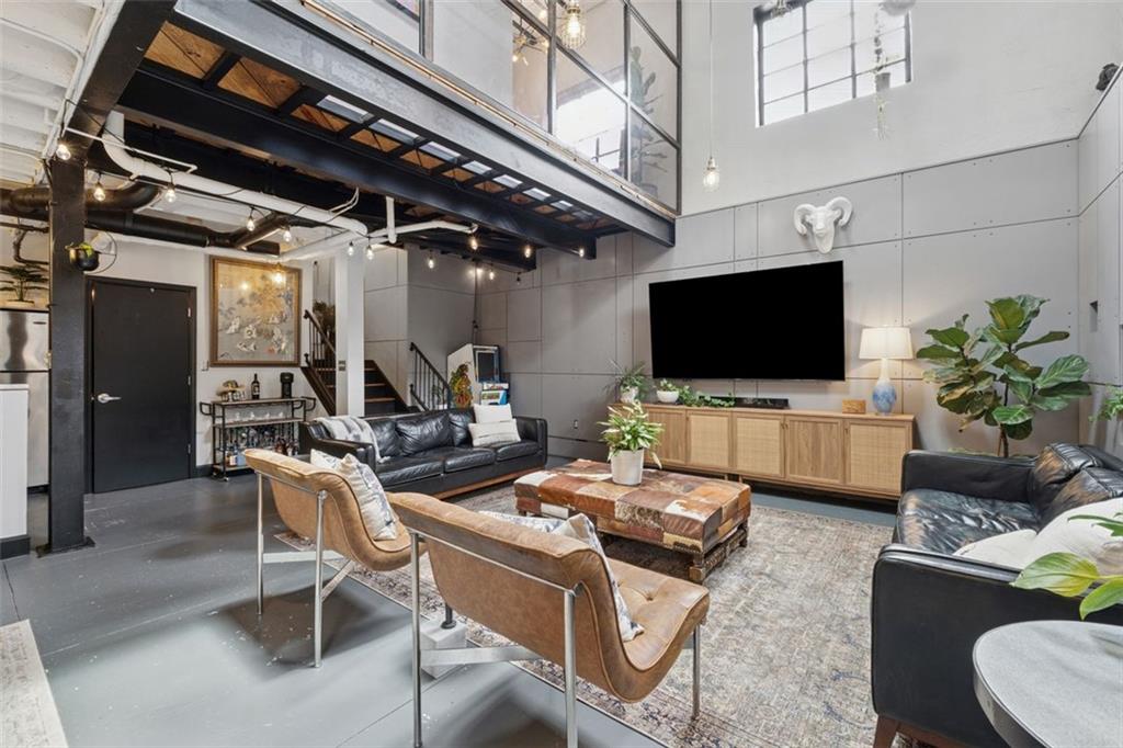 830 DeKalb Avenue Northeast, Unit 11 Atlanta, GA 30307 - Photo 3 of 37 a living room with furniture and a flat screen tv