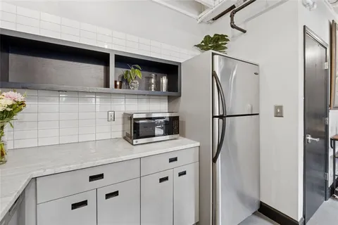 a kitchen with stainless steel appliances granite countertop a stove and a sink with granite countertops
