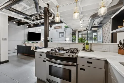 a hallway with a couch and a flat screen tv