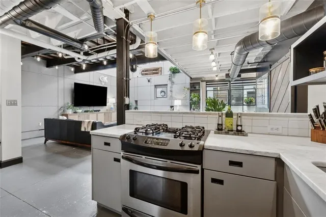 a hallway with a couch and a flat screen tv