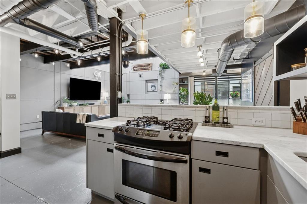 830 DeKalb Avenue Northeast, Unit 11 Atlanta, GA 30307 - Photo 32 of 37 a kitchen with stainless steel appliances granite countertop a stove and a sink with granite countertops