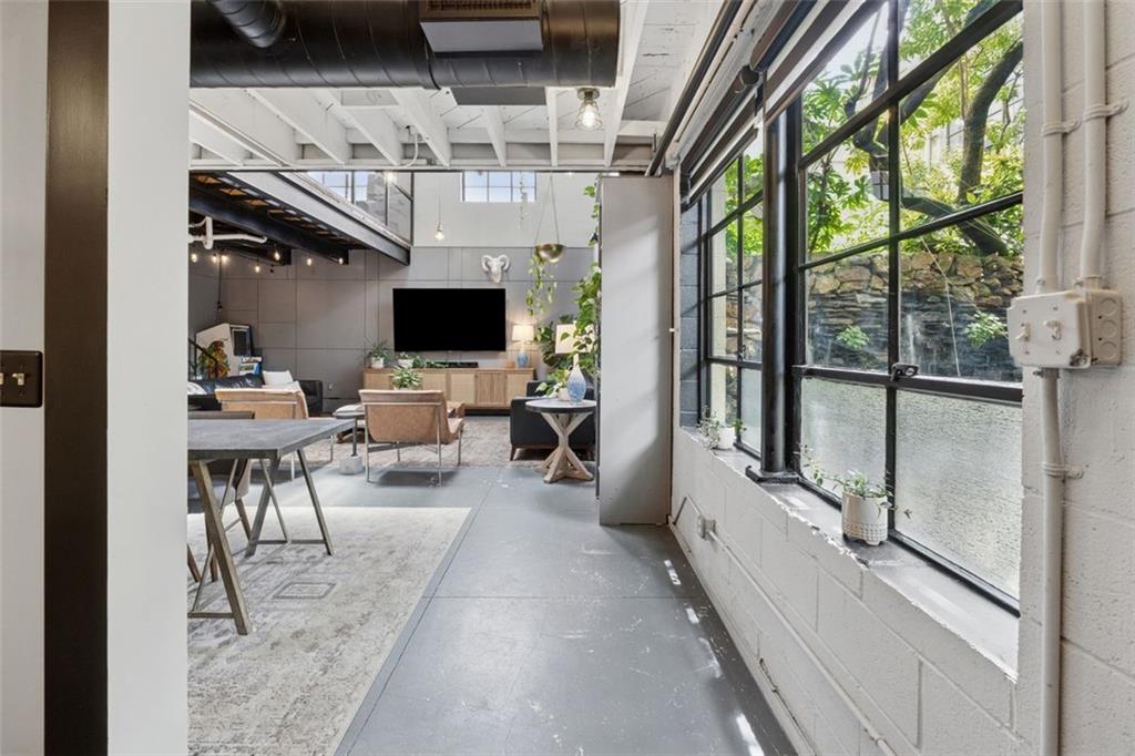 830 DeKalb Avenue Northeast, Unit 11 Atlanta, GA 30307 - Photo 33 of 37 a hallway with a couch and a flat screen tv