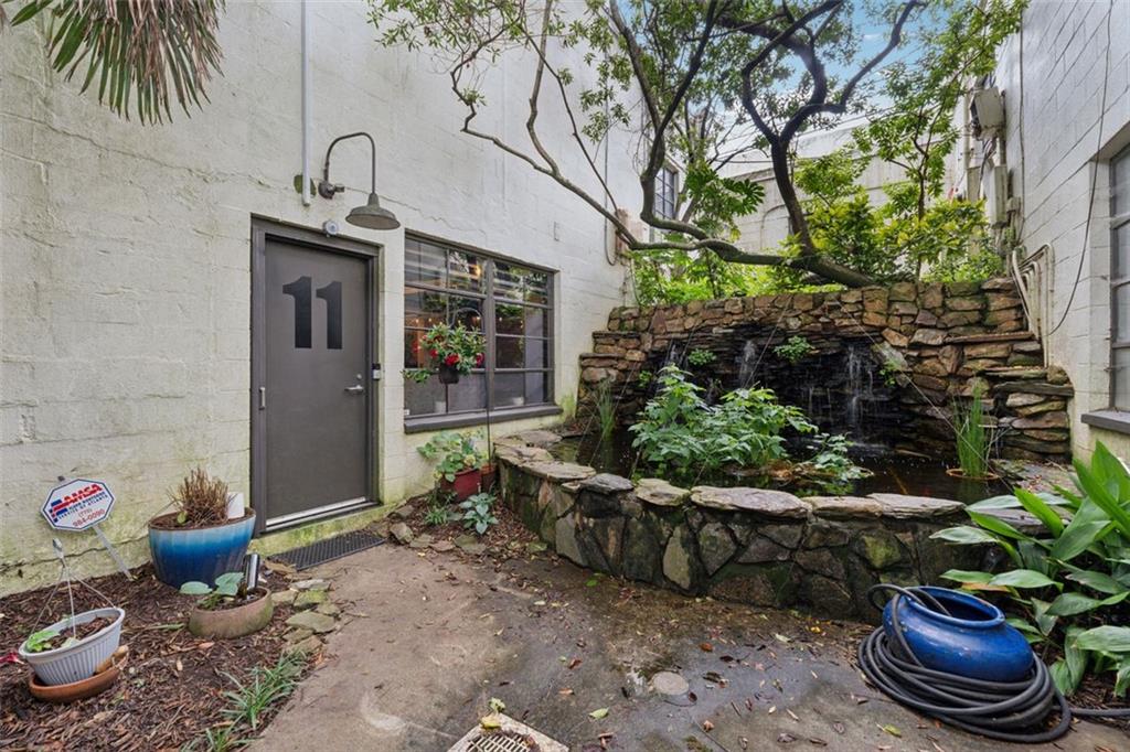 830 DeKalb Avenue Northeast, Unit 11 Atlanta, GA 30307 - Photo 37 of 37 a view of a backyard with plants and palm trees