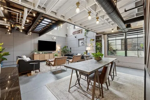 a livingroom with furniture and a flat screen tv