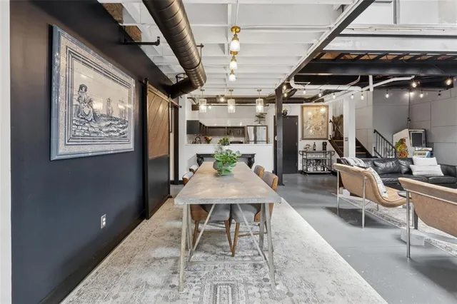 a dining room with furniture and a chandelier