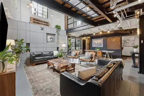 a living room with furniture and a chandelier