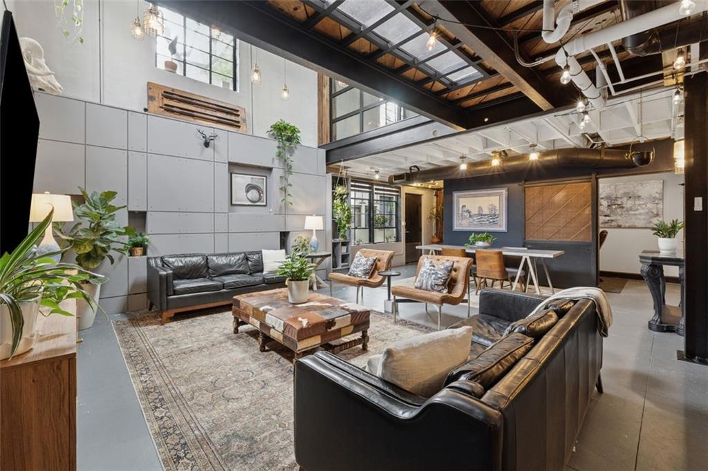 830 DeKalb Avenue Northeast, Unit 11 Atlanta, GA 30307 - Photo 10 of 37 a living room with furniture and a chandelier