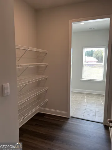 a view of storage and utility room with wooden floor