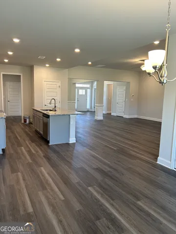 a view of a living room and kitchen with wooden floor
