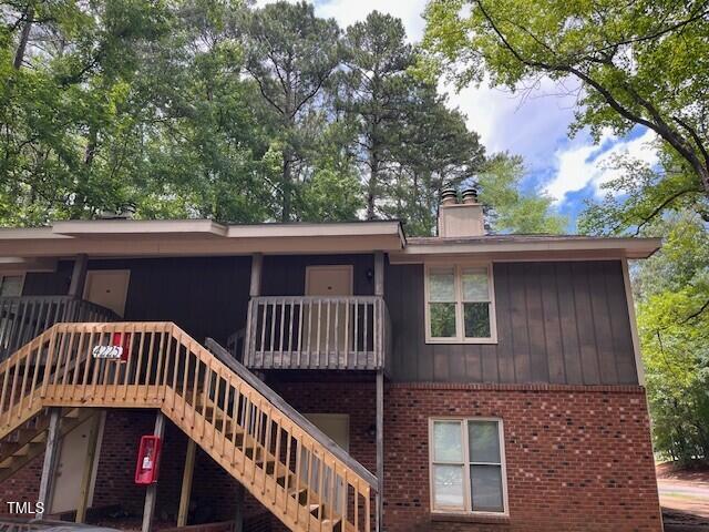 4225 Greencastle Court, Unit D Raleigh, NC 27604 - Photo 1 of 13 a view of a wooden house with large trees