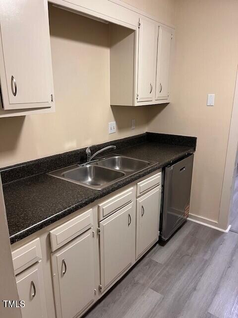 4225 Greencastle Court, Unit D Raleigh, NC 27604 - Photo 4 of 13 a white kitchen with granite countertop white cabinets and a sink