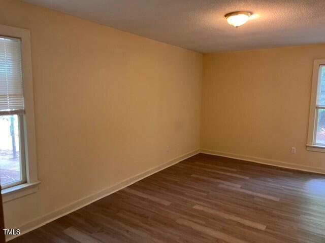 4225 Greencastle Court, Unit D Raleigh, NC 27604 - Photo 6 of 13 an empty room with wooden floor and windows