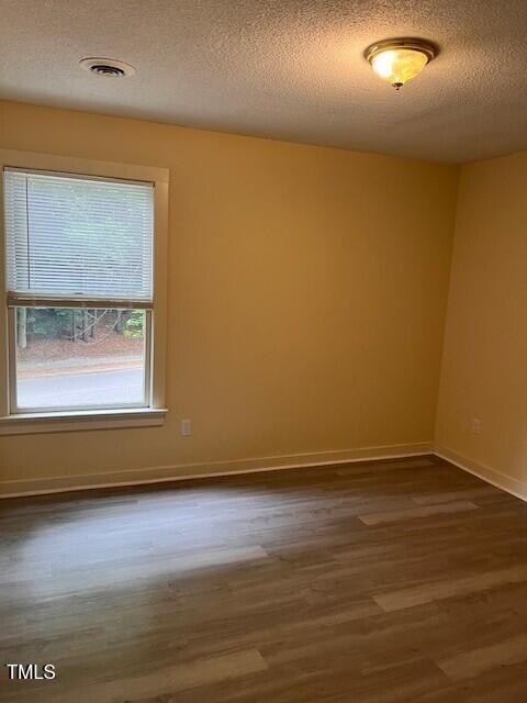 4225 Greencastle Court, Unit D Raleigh, NC 27604 - Photo 9 of 13 a view of an empty room with wooden floor and a window