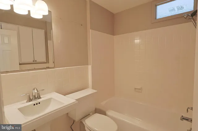 a bathroom with a sink a toilet and bathtub