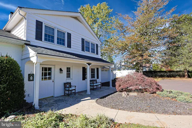 a view of a house with a yard balcony and tree