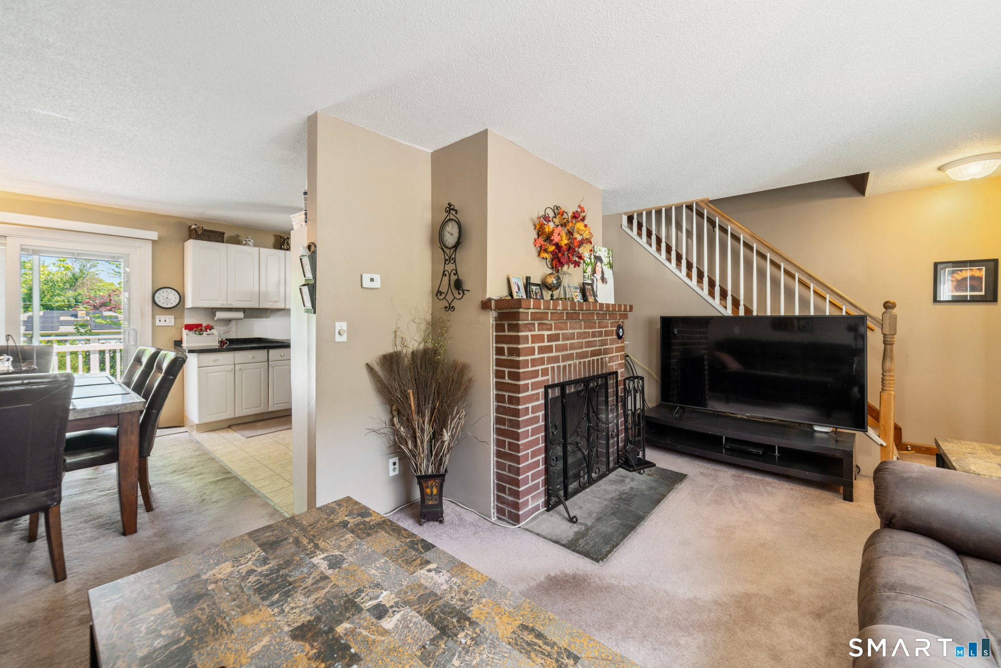 146 Highland Drive Waterbury, CT 06708 - Photo 4 of 31 a living room with furniture a flat screen tv and a fireplace