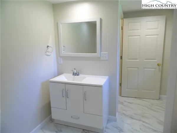 a bathroom with a sink and mirror