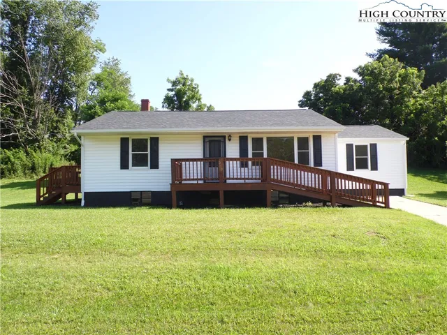 a house that has a big yard with plants and trees