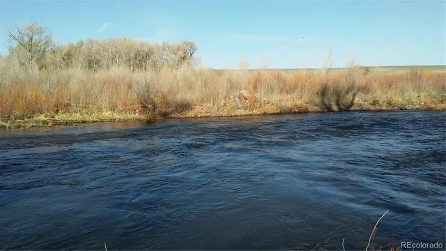 a kitchen with kitchen island granite countertop a sink window and stainless steel appliances