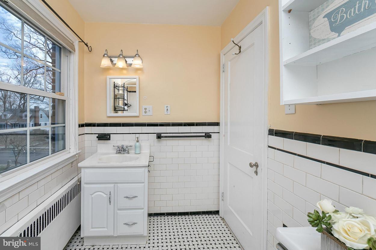 718 Murdock Road Baltimore, MD 21212 - Photo 22 of 30 a bathroom with a sink a mirror and a shower
