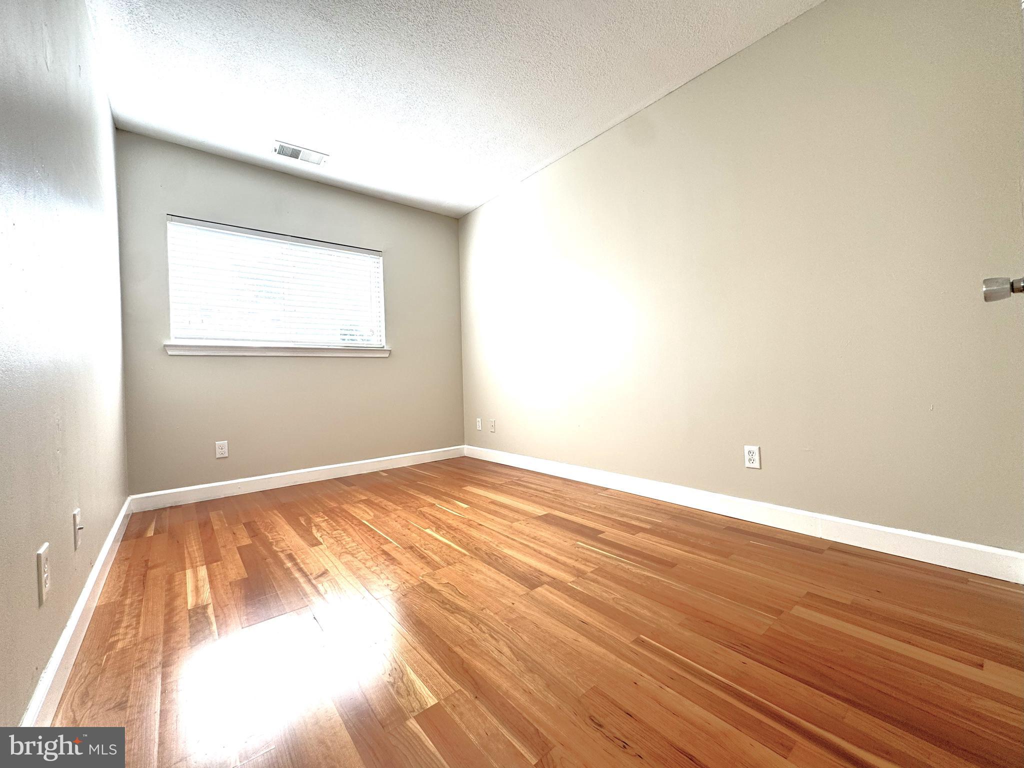 12012 Golf Ridge Court, Unit 102 Fairfax, VA 22033 - Photo 14 of 26 a view of an empty room and wooden floor