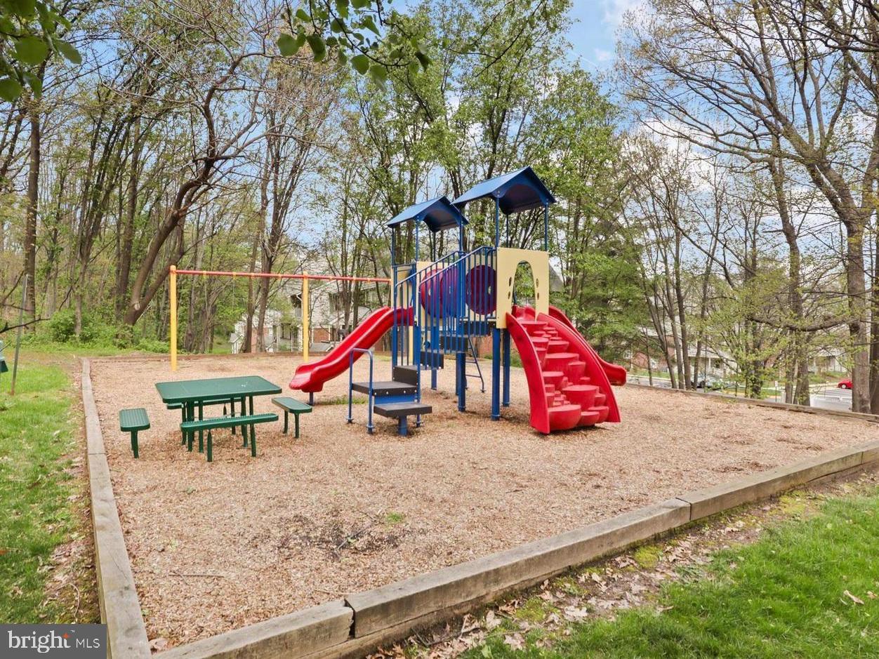 12012 Golf Ridge Court, Unit 102 Fairfax, VA 22033 - Photo 20 of 26 a park with slide and a bench