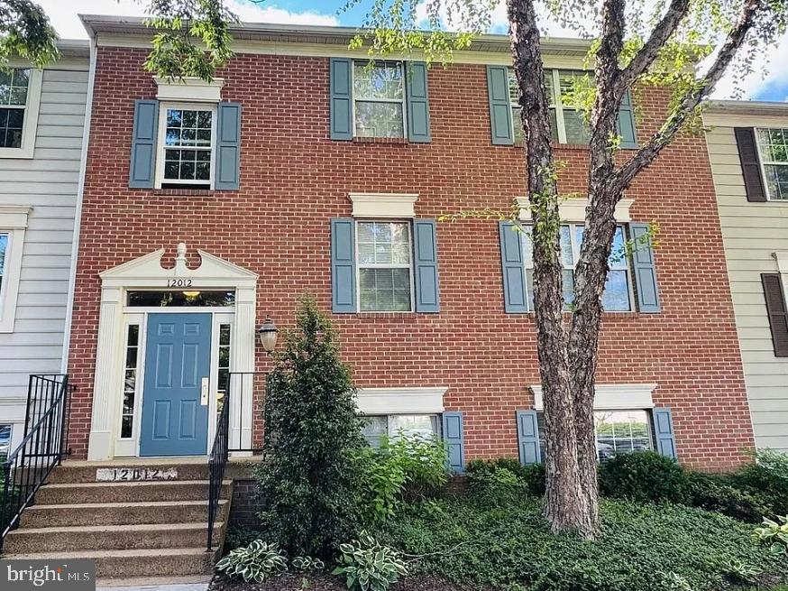 12012 Golf Ridge Court, Unit 102 Fairfax, VA 22033 - Photo 2 of 26 a front view of a house with trees