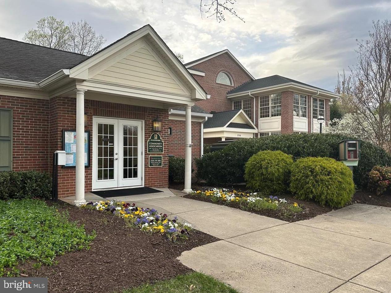 12012 Golf Ridge Court, Unit 102 Fairfax, VA 22033 - Photo 24 of 26 a front view of a house with a garden