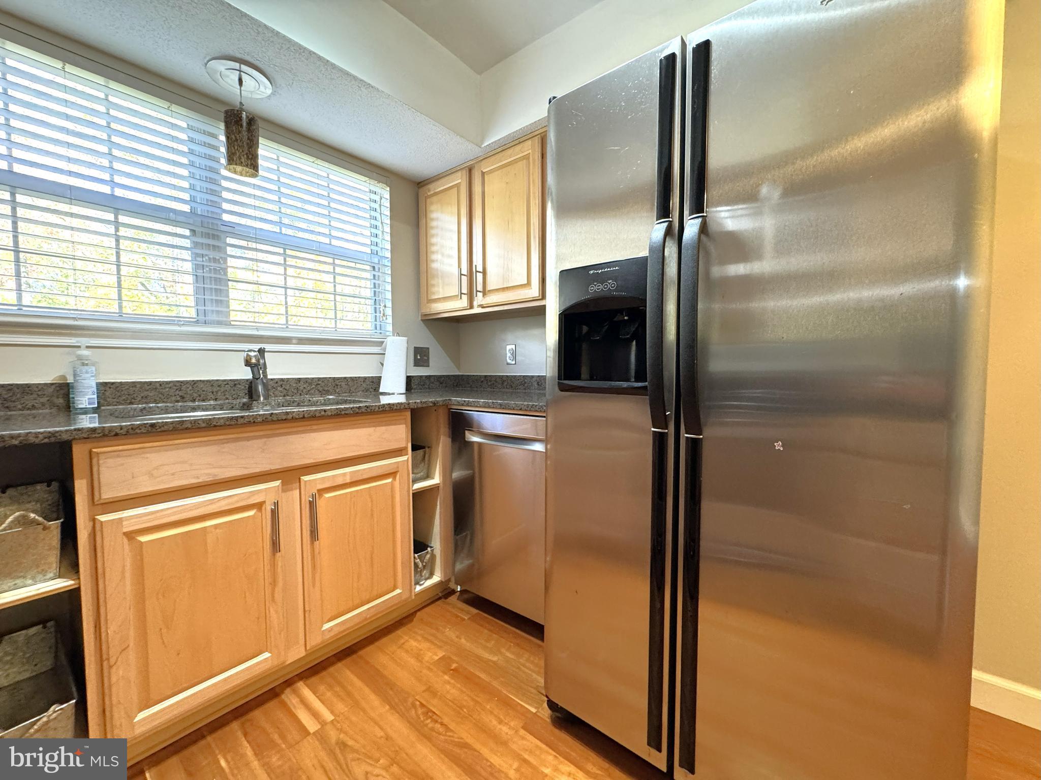 12012 Golf Ridge Court, Unit 102 Fairfax, VA 22033 - Photo 5 of 26 a kitchen with stainless steel appliances granite countertop a refrigerator and a sink