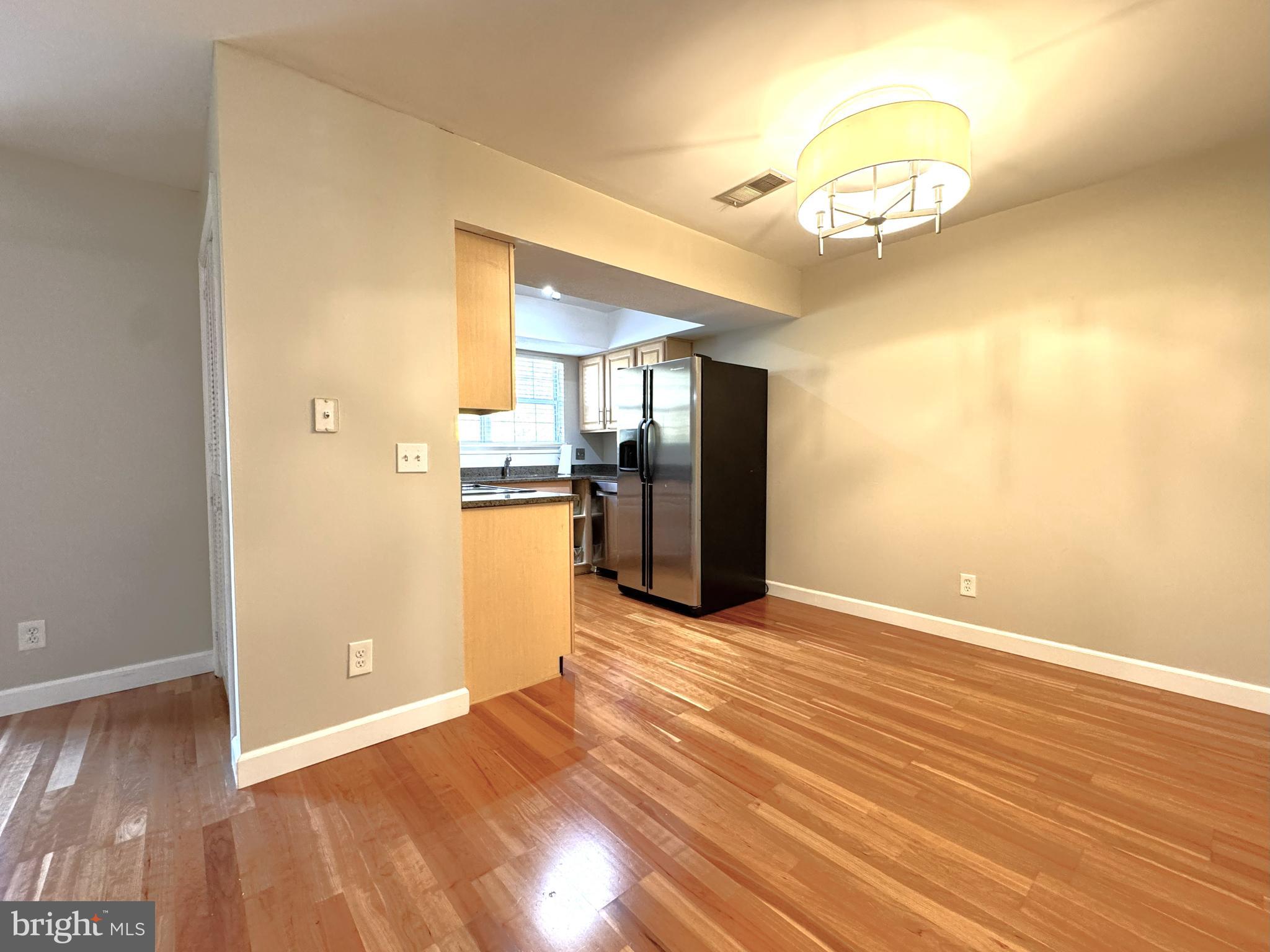 12012 Golf Ridge Court, Unit 102 Fairfax, VA 22033 - Photo 6 of 26 a view of a livingroom with a chandelier