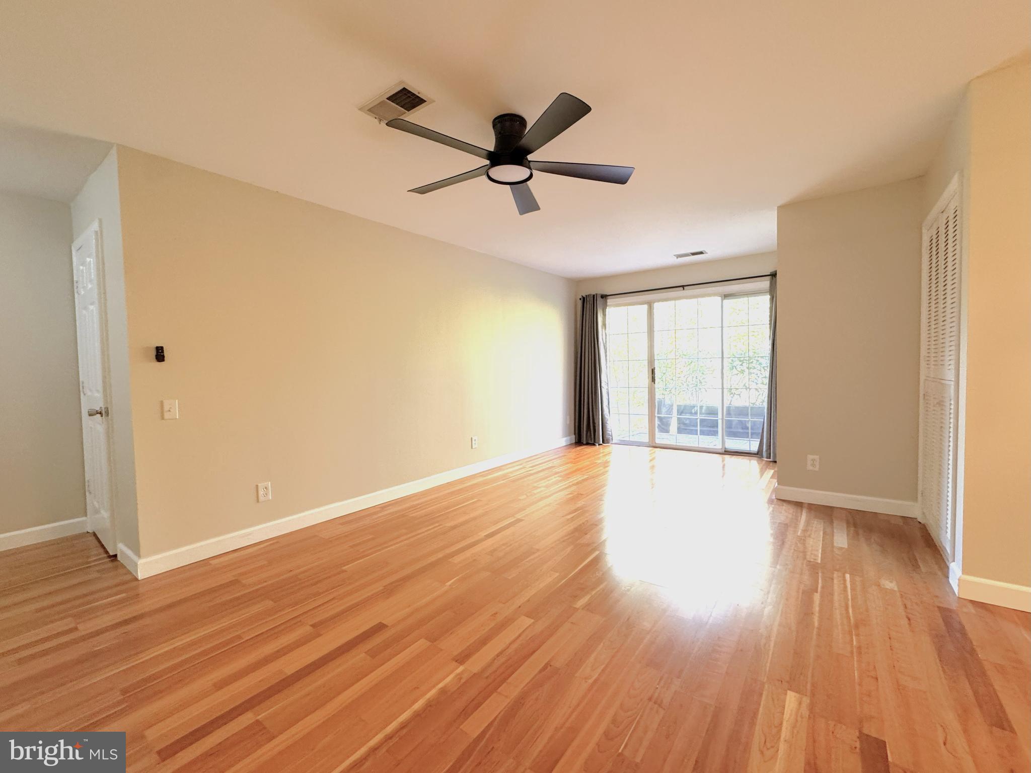12012 Golf Ridge Court, Unit 102 Fairfax, VA 22033 - Photo 8 of 26 a view of empty room with wooden floor and fan