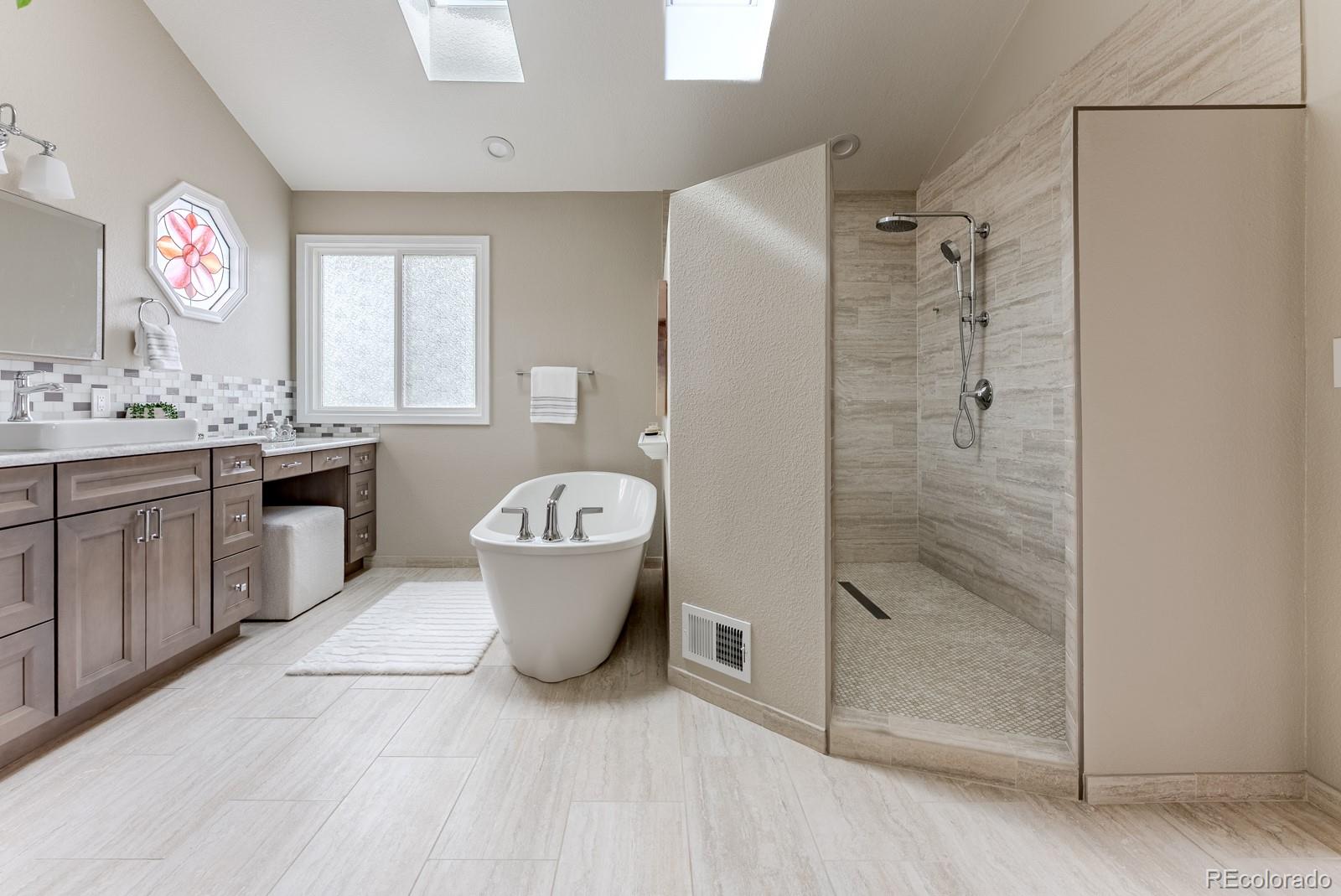 1914 Terrace Drive Highlands Ranch, CO 80126 - Photo 21 of 47 a spacious bathroom with a granite countertop sink a toilet shower and a mirror