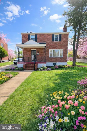 a front view of a house with a yard and fountain in yard