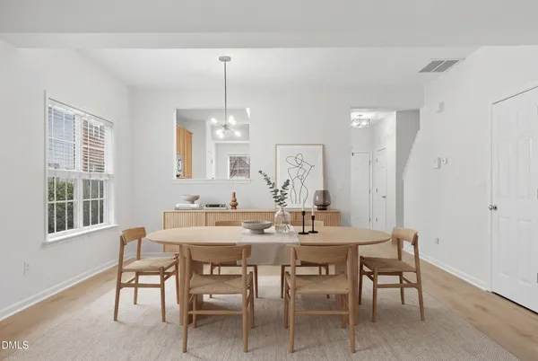a view of a dining room with furniture and chandelier