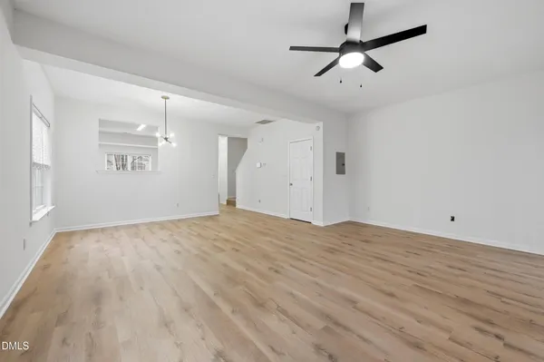 a view of empty room with wooden floor
