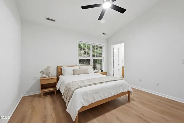 a bedroom with a bed and a window