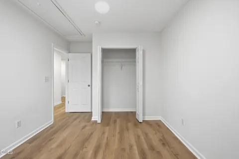 a view of room with wooden floor