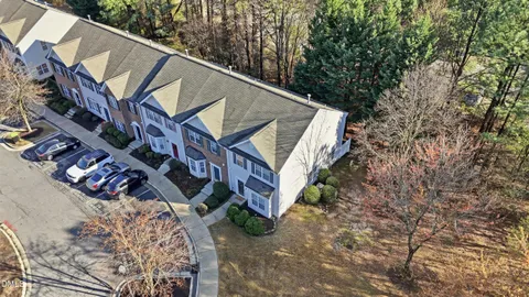 a view of multiple houses with large trees